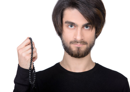 Do you believe in God? Portrait of priest pointing away while standing isolated on whiteの写真素材