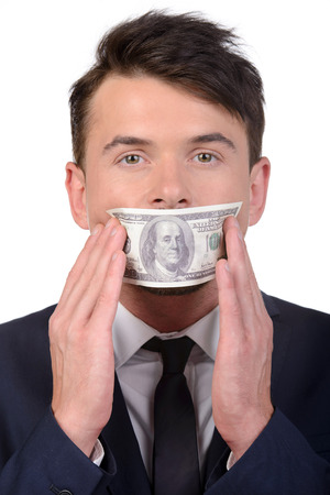 Man with a 100 dollar banknote on his mouth isolated on white backgroundの写真素材