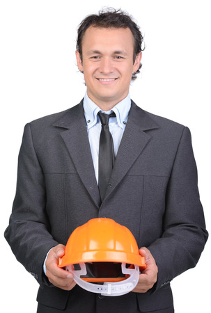Portrait of cheerful young engineer in helmet, isolated on white backgroundの写真素材