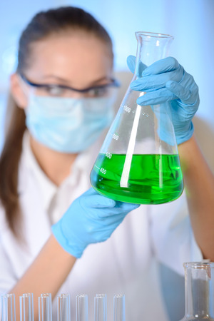Chemist woman testing sample of liquid in laboratoryの写真素材