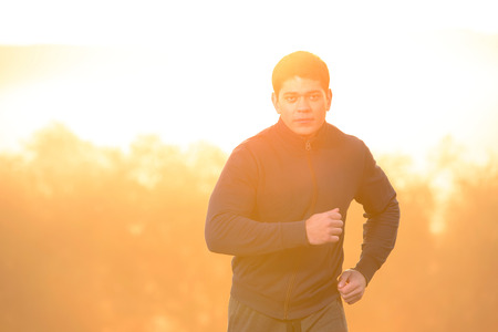 Young man running outdoors in the morning.の写真素材