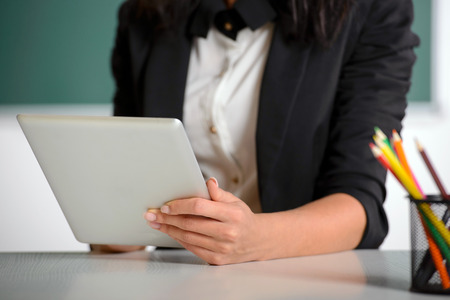 Young smiling student or teacher at the blackboardの写真素材