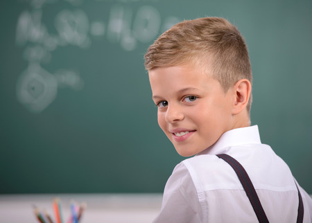Cheerful smiling child at the blackboard. School conceptの写真素材