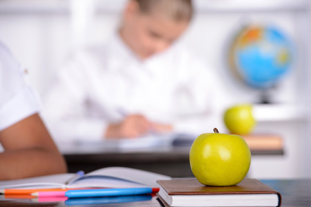 School child with teacher in classroom during lesson. concept of schoolの写真素材