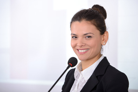 Female speaker at the board. Business conference
