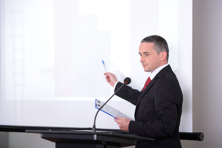Young businessman giving presentation to his colleaguesの写真素材