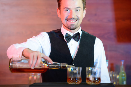 Bartender is making cocktail at bar counterの写真素材