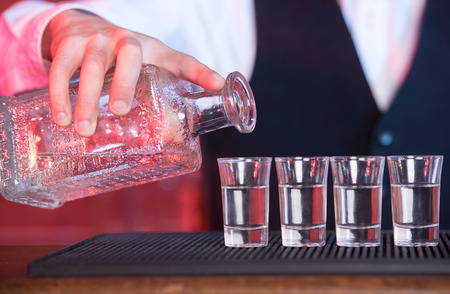 Bartender is making cocktail at bar counterの写真素材