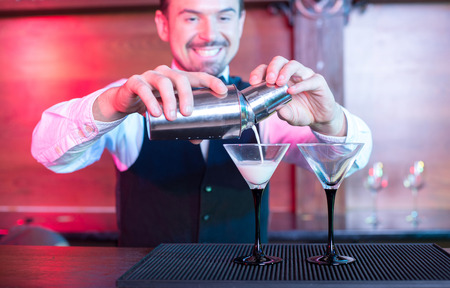 Bartender is making cocktail at bar counterの写真素材