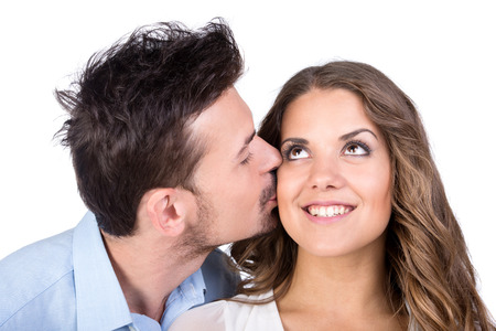 Beautiful couple in love kissing, isolated on white の写真素材