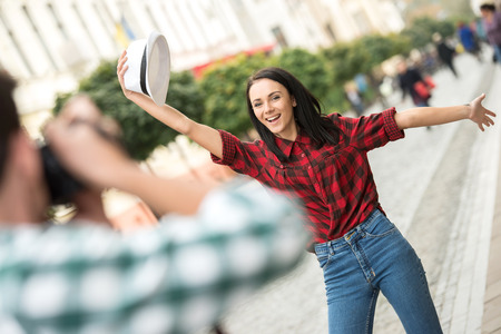 Man is taking picture of girlfriend on tourist journey.の写真素材