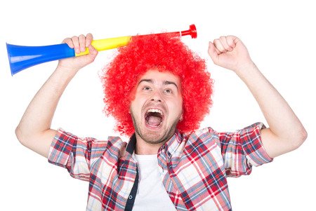 Portrait of football fan celebrates win, isolated on white.の写真素材