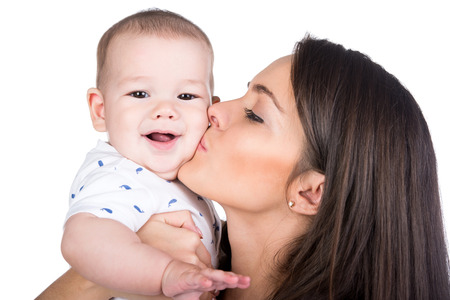 Happy Family. Mother and baby are kissing and hugging.の写真素材