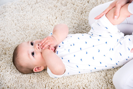 Mother is massaging and exercise to her little baby.