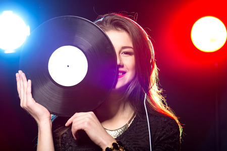 Portrait of the female dj with vinyl record.