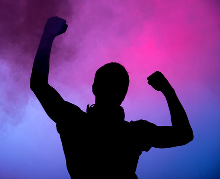 Silhouette of young man, dj, on colored background.の写真素材