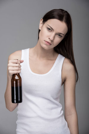 Young woman with alcohol. The concept of bad habits.の写真素材