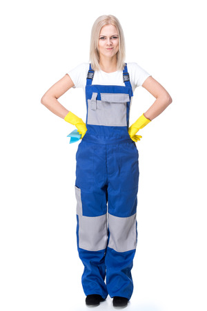 Portrait of female professional cleaner in uniform on the white background.の写真素材