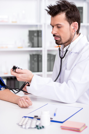 Doctor is checking the blood pressure of the patient.の写真素材