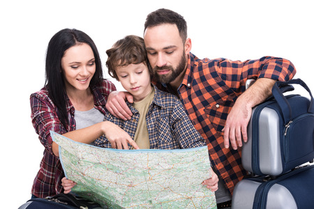 Happy family with luggage and map are ready to travel. Isolated on white background.の写真素材