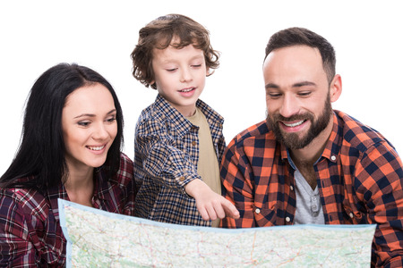 Happy family with luggage and map are ready to travel. Isolated on white background.の写真素材