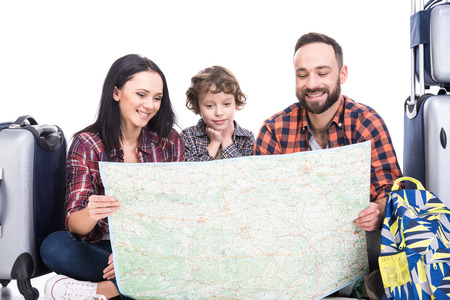 Happy family with luggage and map are ready to travel. Isolated on white background.の写真素材