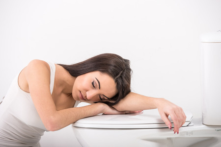 Young woman asleep in the toilet.の写真素材
