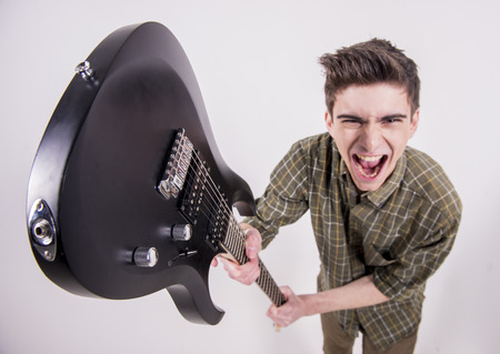 Young guitarist with the electric guitar in studio.の写真素材