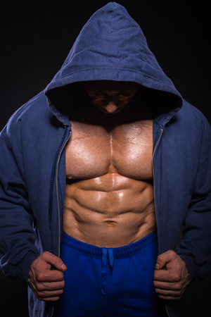 Bodybuilder is posing, showing his muscles. Force, relief, muscle, courage, virility, bodybuilder, bodybuilding.の写真素材