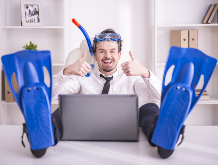 Happy businessman is working in office is wearing in fins.の写真素材