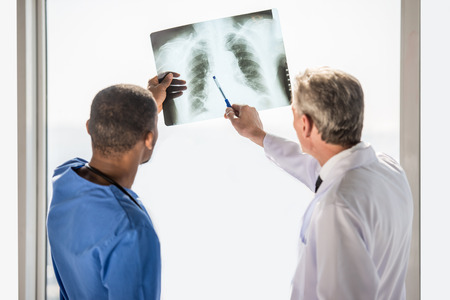 The doctors looking at an x-ray results in hospital.