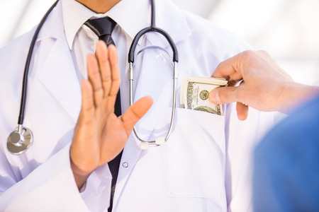Close-up. Corruption. Male giving bribe doctor. Medicine concept.の写真素材