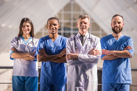 Group of doctors standing with arms crossed in  hospital.