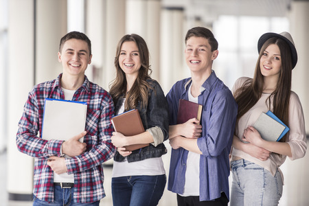 Group of happy young students in a university.