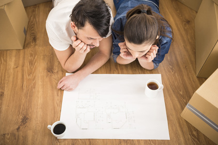 The young happy couple planning a new house. Moving, purchase of new habitation.