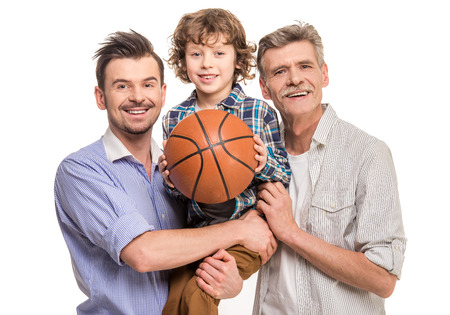 Generation portrait. Grandfather, father and son, isolated a white background. Boy holding in hands...