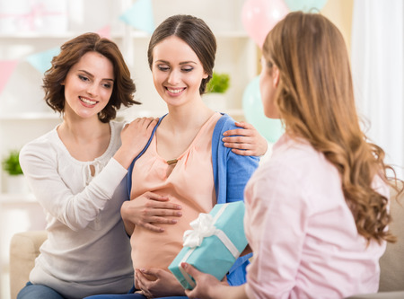 Pregnant woman with friends at a baby shower.の写真素材