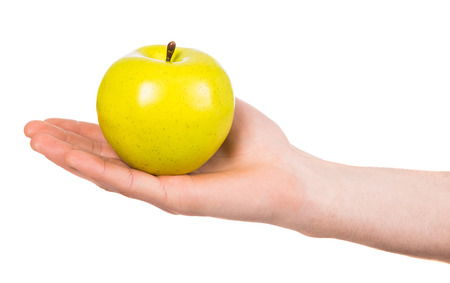 Man's hand with an apple isolated on white background.の写真素材