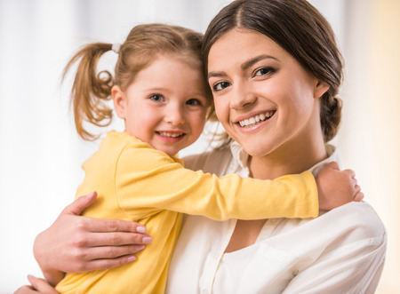 Bright picture of hugging mother and little daughter.の写真素材