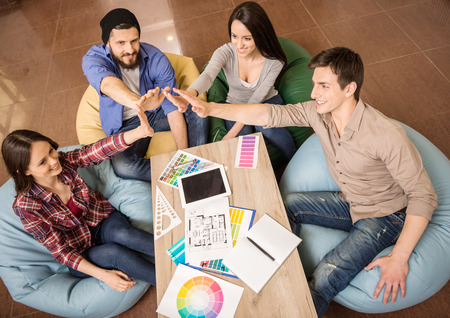 Creative group of designers putting hands together. Team work.の写真素材