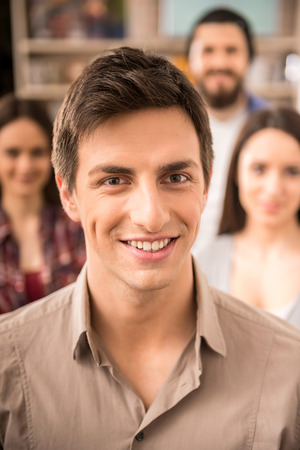 Creative group of designers dressed casual looking at camera and smiling.の写真素材