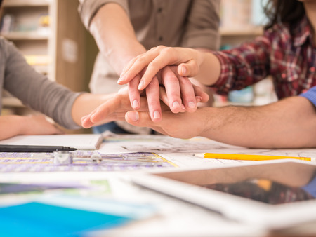 Creative group of designers putting hands together. Team work. Creative group of designers putting hands together. Team work.