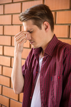A portrait of a young handsome man lost in his thoughts.の写真素材