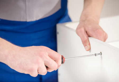 Close-up of repairman using repair tools at home interior.の写真素材