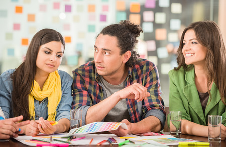 Young interior designers sitting at office and brainstorming.