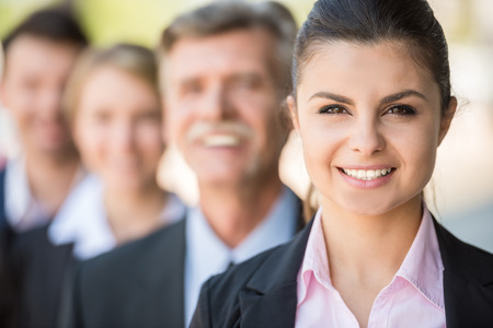 Group of business people standing in front of office and looking at camera.の写真素材
