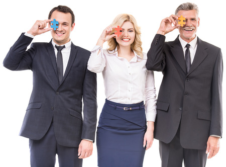 Image of confident business people wanting to put pieces of puzzle together. Team work.の写真素材