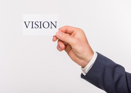 Man holding a card with message text written on it. Close-up.の写真素材