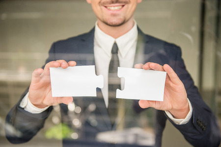 Business man holding pieces of puzzle. Business solution concept.の写真素材