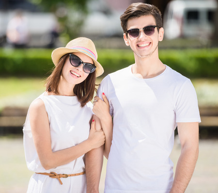 Young nifty couple walking along the street on summer day.の写真素材